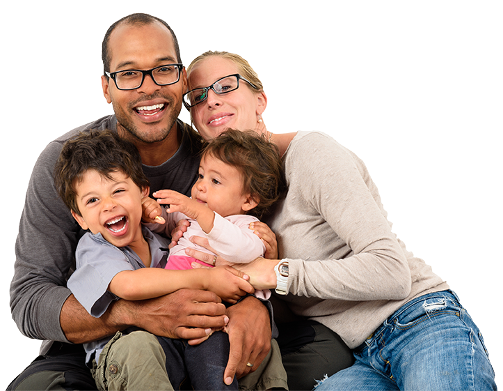 A happy family of four sits together closely, smiling and laughing. The father and mother, who are wearing glasses, look relaxed and content in their casual attire. Nestled between them, the young boy and girl giggle with joy, embodying the wellness lifestyle central to their health in Central Florida.