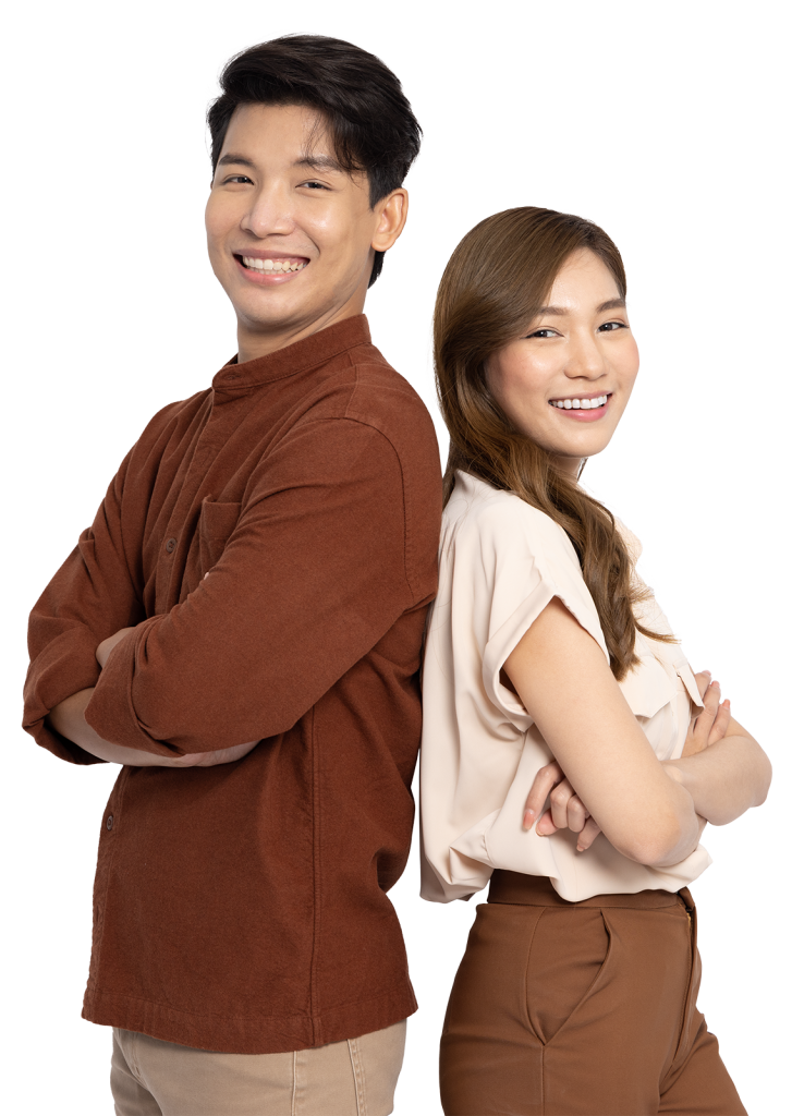 A man and a woman stand back-to-back, both smiling confidently. The man has short, dark hair and wears a brown long-sleeve shirt with beige pants. The woman has long, light brown hair and is dressed in a light-colored blouse with brown pants.